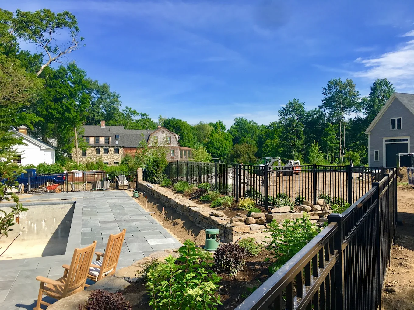 Black aluminum fence with stonework